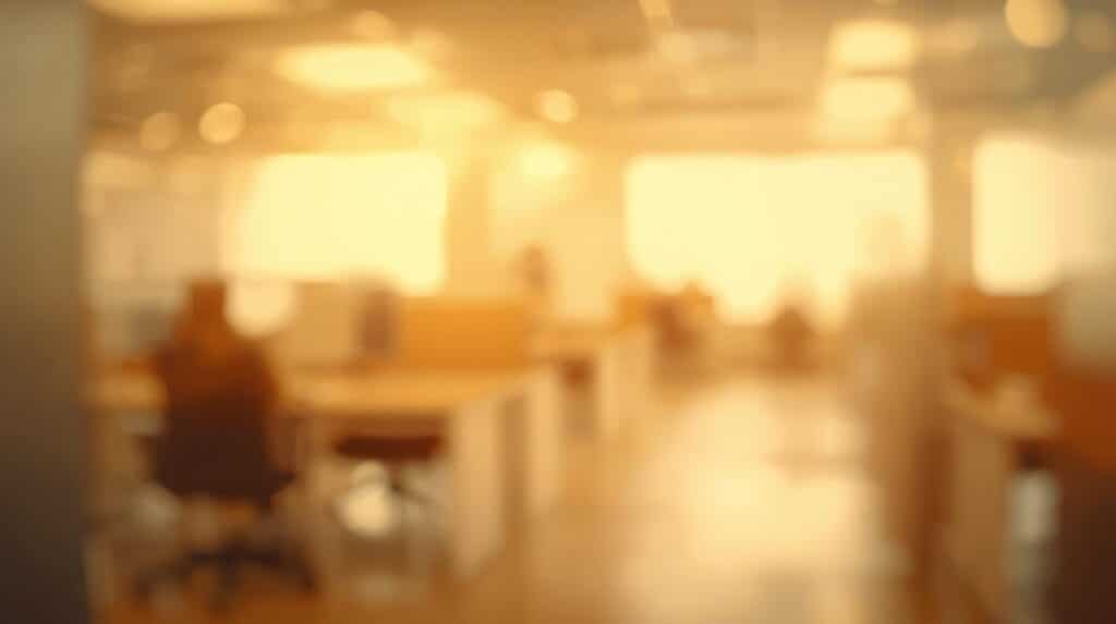 A blurred office environment in warm amber and neutral tones.